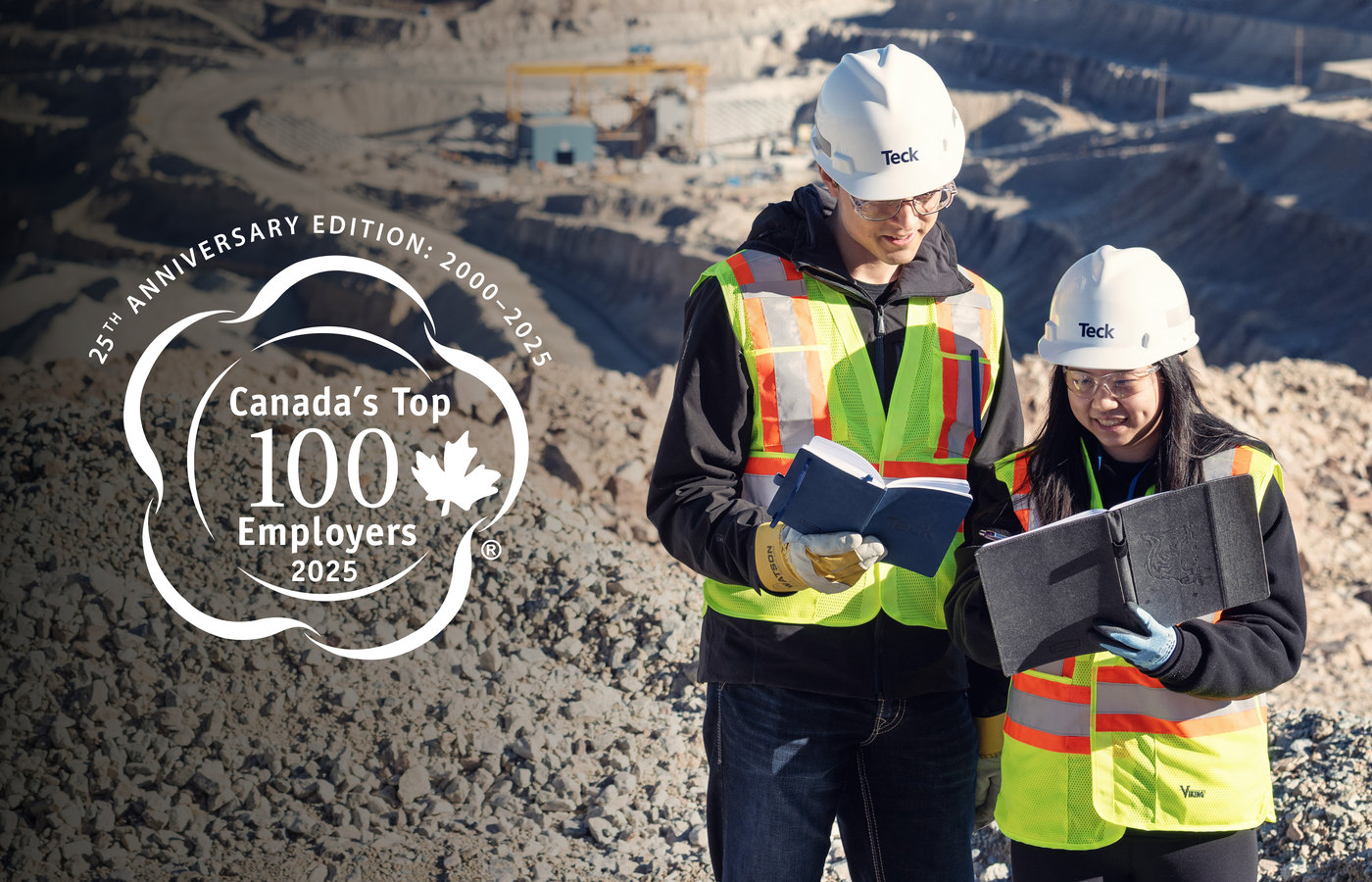 Two workers in safety gear reviewing documents at a mining site, with award logo displayed.