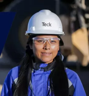 Person in PPE gear with hard hat and safety glasses.